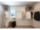 Organized walk-in closet with installed shelving and hanging rods filled with clothing and storage boxes at 217 Windy Knoll Dr, Graham, NC 27253