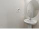 Half bath features a pedestal sink and round mirror at 239 Faith Avenue, Sanford, NC 27330