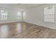Bedroom features hardwood floors, white walls, and large windows at 239 Faith Avenue, Sanford, NC 27330