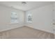 Bright bedroom features neutral carpet, white walls, and natural light from two windows at 239 Faith Avenue, Sanford, NC 27330
