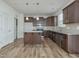 Beautiful kitchen featuring stainless steel appliances, an island, and wood floors at 239 Faith Avenue, Sanford, NC 27330