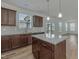 Well-lit kitchen featuring a central island and backyard views through sliding doors at 239 Faith Avenue, Sanford, NC 27330