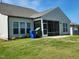 Expansive backyard featuring a covered screened in patio, manicured lawn and well kept landscaping at 2432 Nassau Trce, Fuquay Varina, NC 27526