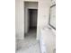 Bright bathroom featuring a double vanity, modern fixtures, white cabinets and marble floors at 2432 Nassau Trce, Fuquay Varina, NC 27526