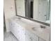 Bright bathroom featuring a double vanity, modern fixtures, white cabinets and marble floors at 2432 Nassau Trce, Fuquay Varina, NC 27526