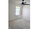 Bright bedroom featuring plush carpet, neutral walls, a modern ceiling fan, and a window with natural light at 2432 Nassau Trce, Fuquay Varina, NC 27526