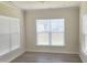 Empty bright bedroom featuring hardwood floors, crown moulding and multiple windows with blinds at 2432 Nassau Trce, Fuquay Varina, NC 27526