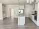 Bright, open kitchen featuring a large island, stainless steel appliances, and white cabinetry at 2432 Nassau Trce, Fuquay Varina, NC 27526
