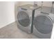 A modern laundry room featuring new Whirlpool washer and dryer units, with neutral vinyl flooring at 2432 Nassau Trce, Fuquay Varina, NC 27526