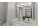 Bathroom with double sinks, white countertop, and mirror reflecting the bedroom at 2521 Friedland Pl # 303, Raleigh, NC 27617