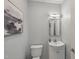 Bathroom featuring a framed mirror, light fixture, and vanity with a white sink and storage at 2521 Friedland Pl # 303, Raleigh, NC 27617