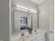 Bathroom featuring double sinks, white countertop, and mirror reflecting the bedroom at 2521 Friedland Pl # 303, Raleigh, NC 27617