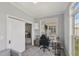 Bedroom with neutral tones, featuring a large window and modern desk setup at 2521 Friedland Pl # 303, Raleigh, NC 27617