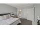 Bedroom view towards bathroom and closet with neutral decor, a comfortable bed, and white trim at 2521 Friedland Pl # 303, Raleigh, NC 27617