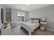 Cozy bedroom featuring a comfortable bed with decorative pillows and a sun-filled window at 2521 Friedland Pl # 303, Raleigh, NC 27617