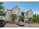 Multi-story home showcasing tan siding, brick accents, well-maintained landscaping, and convenient parking at 2521 Friedland Pl # 303, Raleigh, NC 27617