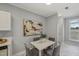 Eat-in kitchen features white cabinets, marble floors, stainless appliances, table and seating at 2521 Friedland Pl # 303, Raleigh, NC 27617