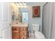 Well-lit bathroom with oak cabinets, a marble countertop and a mirrored medicine cabinet at 26 Shadymont Dr, Pittsboro, NC 27312