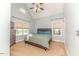 Bedroom with a blue accent, carpeted floor, ceiling fan, and a large window for natural light at 26 Shadymont Dr, Pittsboro, NC 27312