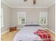 Neutral bedroom has two windows and a ceiling fan at 26 Shadymont Dr, Pittsboro, NC 27312