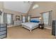 Spacious main bedroom offering neutral tones, vaulted ceiling, generous windows, and carpeted floor at 26 Shadymont Dr, Pittsboro, NC 27312