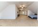 This large bonus room boasts high ceilings, a bedroom area, a tv and ample storage at 26 Shadymont Dr, Pittsboro, NC 27312