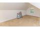 Small bonus room features one window and dollhouse decor at 26 Shadymont Dr, Pittsboro, NC 27312