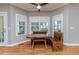 Bright dining area with a rustic table set and natural light streaming through large windows at 26 Shadymont Dr, Pittsboro, NC 27312