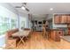 Cozy dining area adjacent to the kitchen, featuring a built-in bench and plenty of natural light at 26 Shadymont Dr, Pittsboro, NC 27312