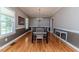 Traditional dining room with hardwood flooring, chandelier lighting, and multiple windows providing natural light at 26 Shadymont Dr, Pittsboro, NC 27312