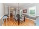 Traditional dining room with hardwood flooring, chandelier lighting, and large windows with trim at 26 Shadymont Dr, Pittsboro, NC 27312