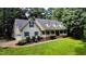 Beautiful home showcasing a long front porch, manicured landscaping, and classic design elements at 26 Shadymont Dr, Pittsboro, NC 27312