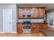 Well-equipped kitchen featuring wooden cabinets, stainless steel appliances, and granite countertops at 26 Shadymont Dr, Pittsboro, NC 27312