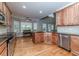 Spacious kitchen with wood cabinets, hardwood floors, and stainless steel appliances with eat in dining area at 26 Shadymont Dr, Pittsboro, NC 27312