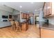 Open kitchen with granite countertops, stainless steel appliances, and hardwood floors flowing into the living area at 26 Shadymont Dr, Pittsboro, NC 27312