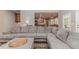 Comfortable living room featuring a large sectional sofa and open floor plan into the kitchen at 26 Shadymont Dr, Pittsboro, NC 27312