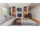 Bright living room with fireplace, built-in shelves, comfortable seating, and hardwood floors at 26 Shadymont Dr, Pittsboro, NC 27312