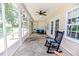 Relax on this screened porch with views of the outdoors, rocking chair, and ceiling fan at 26 Shadymont Dr, Pittsboro, NC 27312