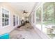 Spacious screened-in porch with ceiling fans and views of the backyard at 26 Shadymont Dr, Pittsboro, NC 27312