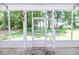 Enjoy this home's screened porch that overlooks a lush green lawn and mature trees at 26 Shadymont Dr, Pittsboro, NC 27312