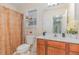 Bright bathroom featuring a single sink vanity, decorative shelf, and a shower with patterned curtain at 2810 Catamaunt, Durham, NC 27704
