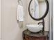 Bathroom featuring a vanity with a decorative mirror, granite countertop, and bronze faucet at 309 E End Ave, Durham, NC 27703