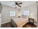 Bright bedroom features two windows, a ceiling fan, and comfortable quilt bedding at 309 E End Ave, Durham, NC 27703