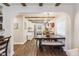 Bright dining room with a large table, bench seating, and a view into the kitchen, enhanced by wood beam accents at 309 E End Ave, Durham, NC 27703