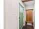 Inviting entryway featuring a green front door, a convenient coat rack with bench, and dark wood-look flooring at 309 E End Ave, Durham, NC 27703