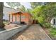 Exterior angle of home with gravel driveway, backyard fence, and a covered front porch at 309 E End Ave, Durham, NC 27703