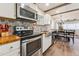 Kitchen featuring stainless appliances, a stylish backsplash, and open dining area at 309 E End Ave, Durham, NC 27703