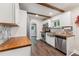 Charming kitchen features butcher block counters, stainless appliances, and decorative backsplash at 309 E End Ave, Durham, NC 27703