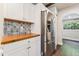Bright kitchen featuring stainless steel refrigerator and custom tile backsplash at 309 E End Ave, Durham, NC 27703