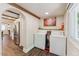 Well-lit laundry room with washer, dryer, and direct kitchen access at 309 E End Ave, Durham, NC 27703